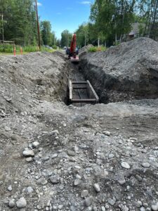 Excavation site with a trench and construction equipment.