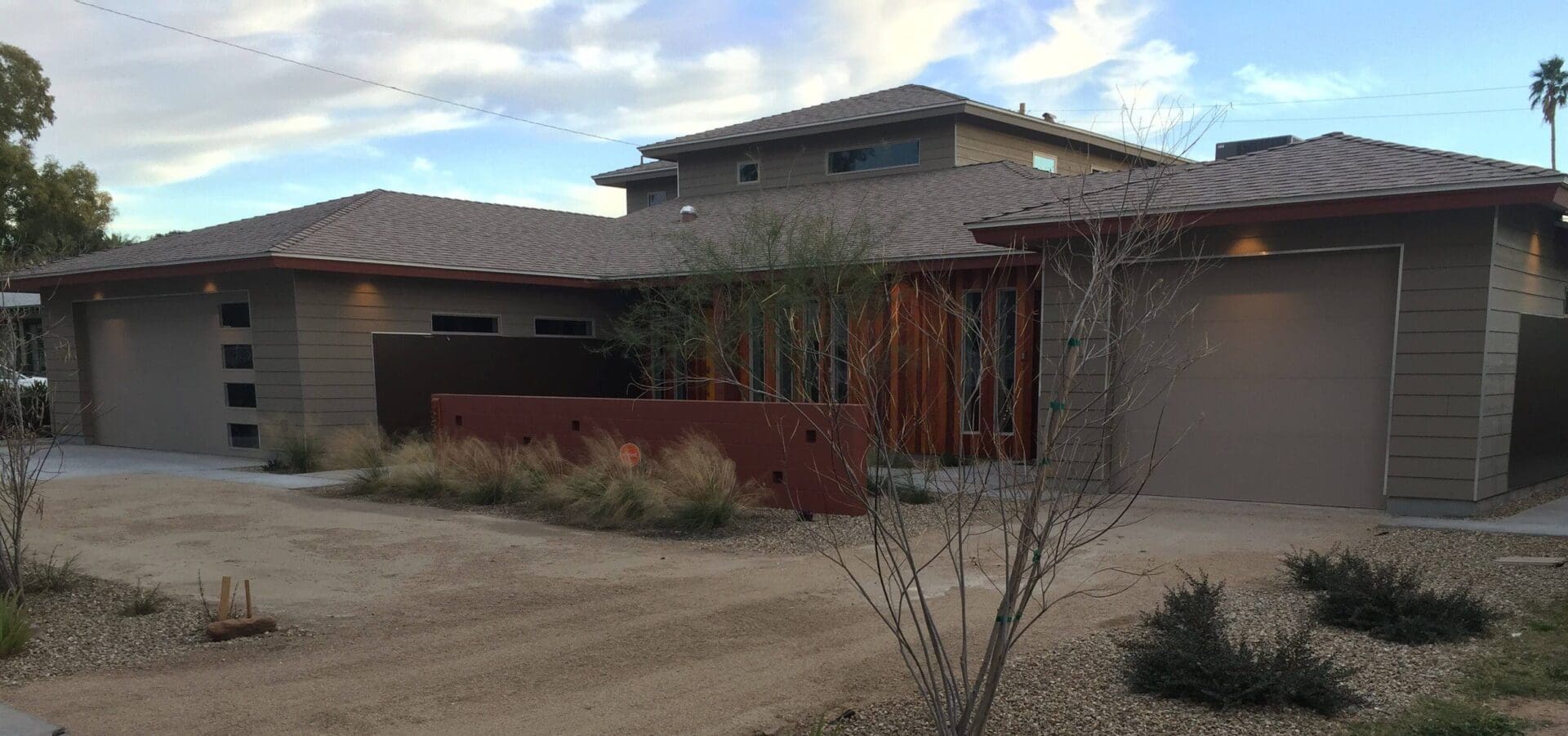 Modern house with multiple garages and driveway.