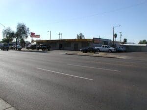 Street view with parked cars and buildings.